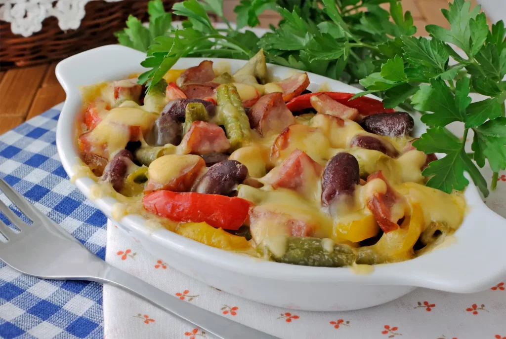 Roasted sausage with zucchini, peppers, and carrots in a skillet