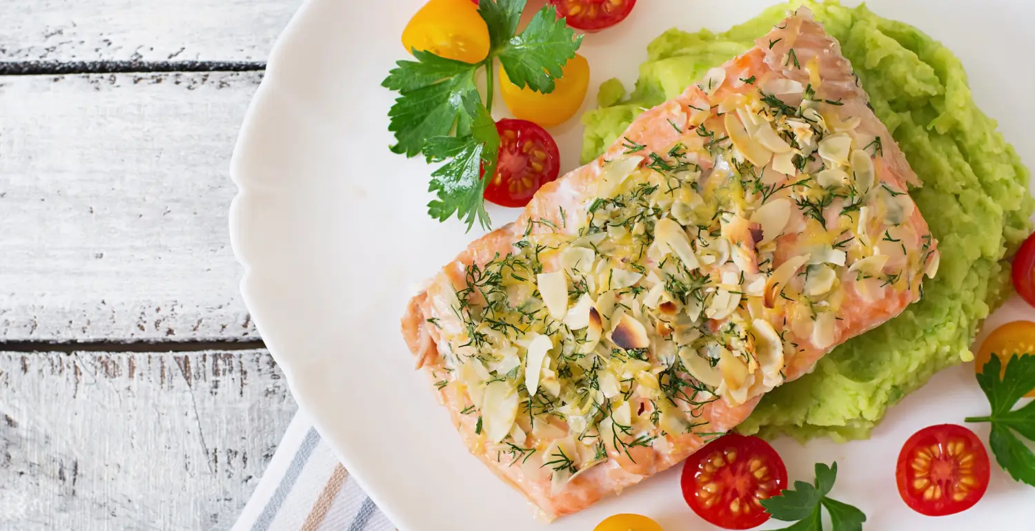 Salmon fillet with lemon-dill sauce, roasted asparagus, and quinoa.