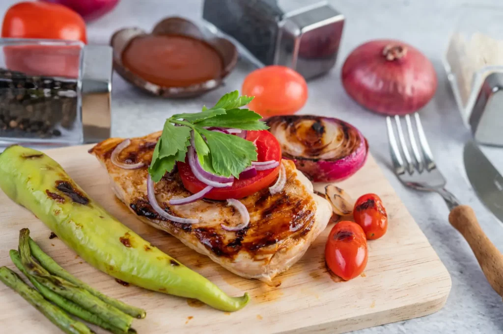 Balsamic chicken recipe served with roasted vegetables and potatoes.