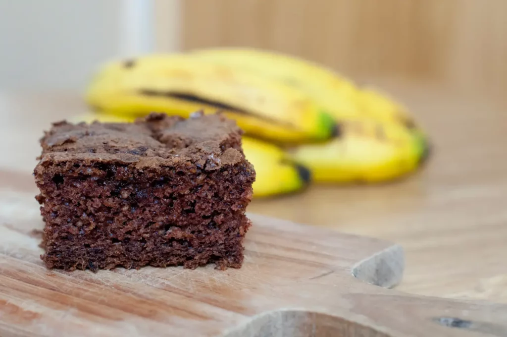 Banana Brownies with Chocolate Glaze on a Rustic Tray.