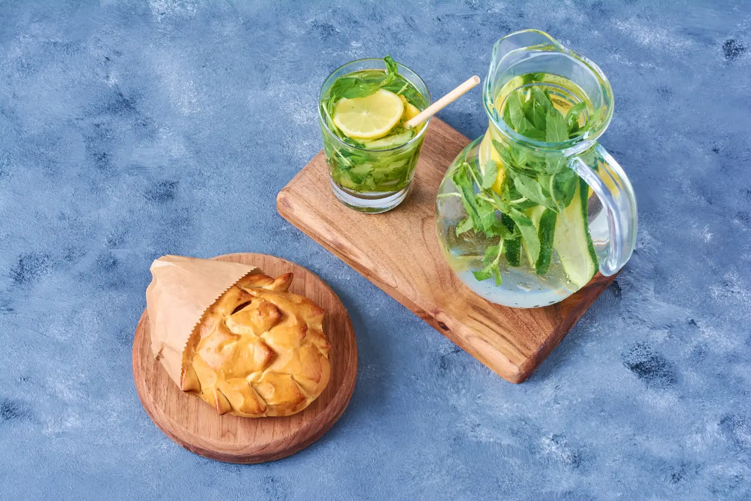 Fresh lemon balm leaves with iced tea and syrup on a kitchen counter