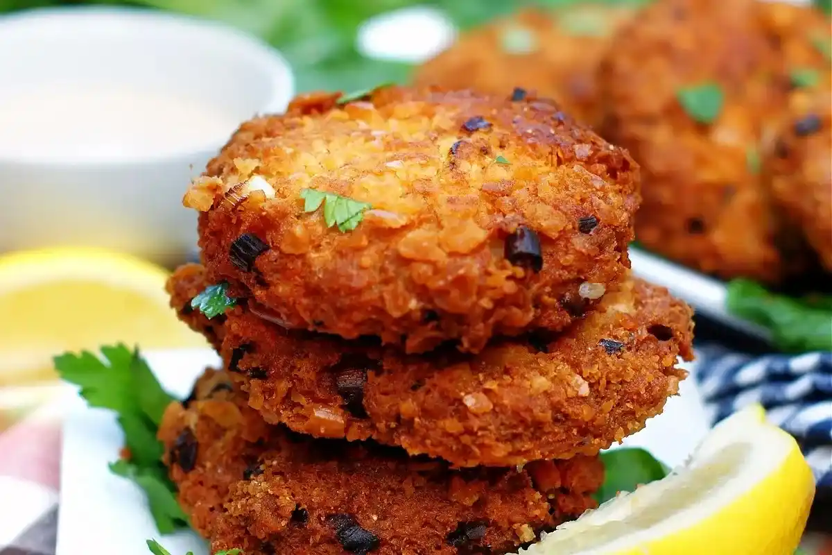 Golden, crispy salmon patties with tartar sauce and lemon