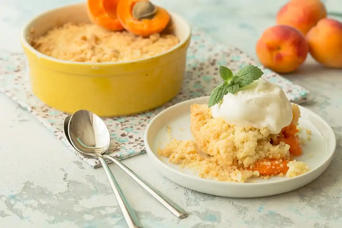 Golden peach cobbler with cake mix crust and vanilla ice cream