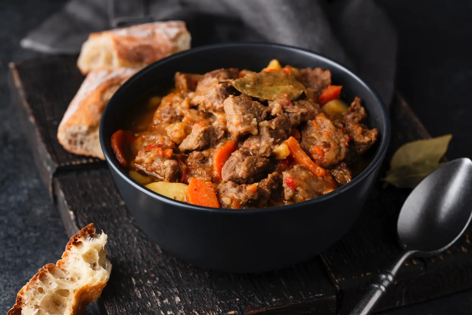 Smothered turkey necks in gravy served with cornbread and potatoes