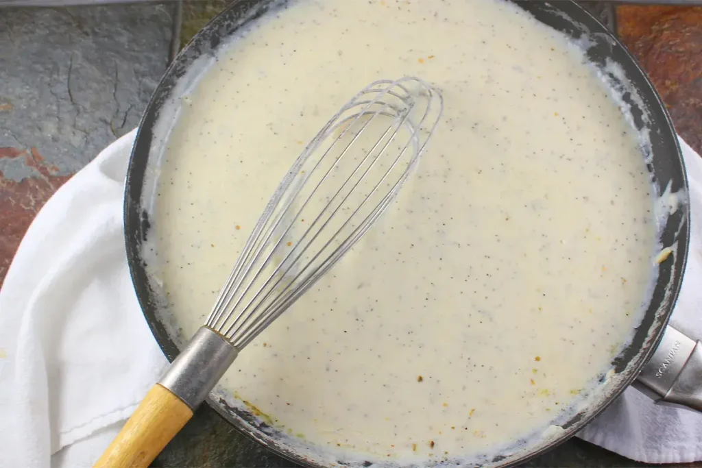 Whisking butter and flour to make a roux for white gravy