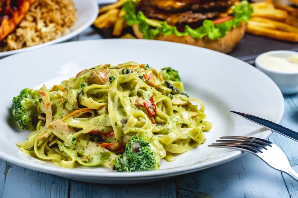 Plate of creamy broccoli pasta with Parmesan and fresh basil