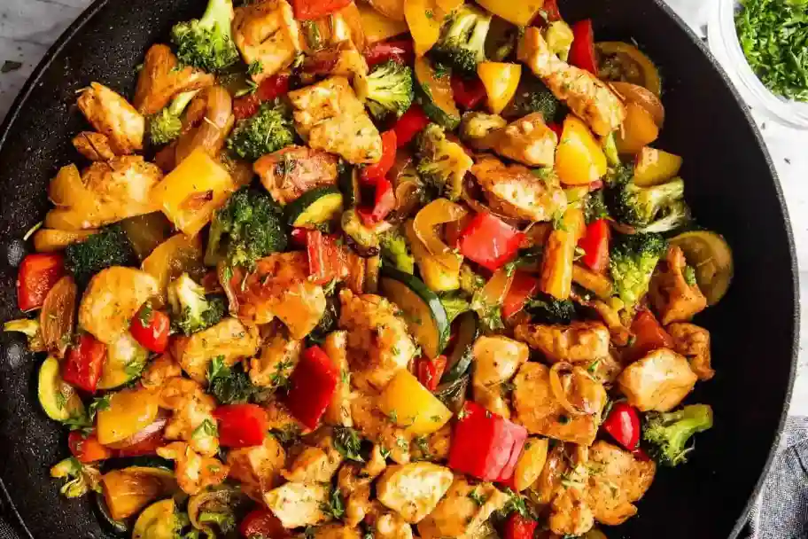 One-pot chicken and vegetable dish in a Dutch oven with fresh thyme.