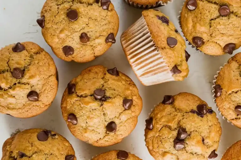 Freshly baked zucchini chocolate chip muffins with golden tops and chocolate chips