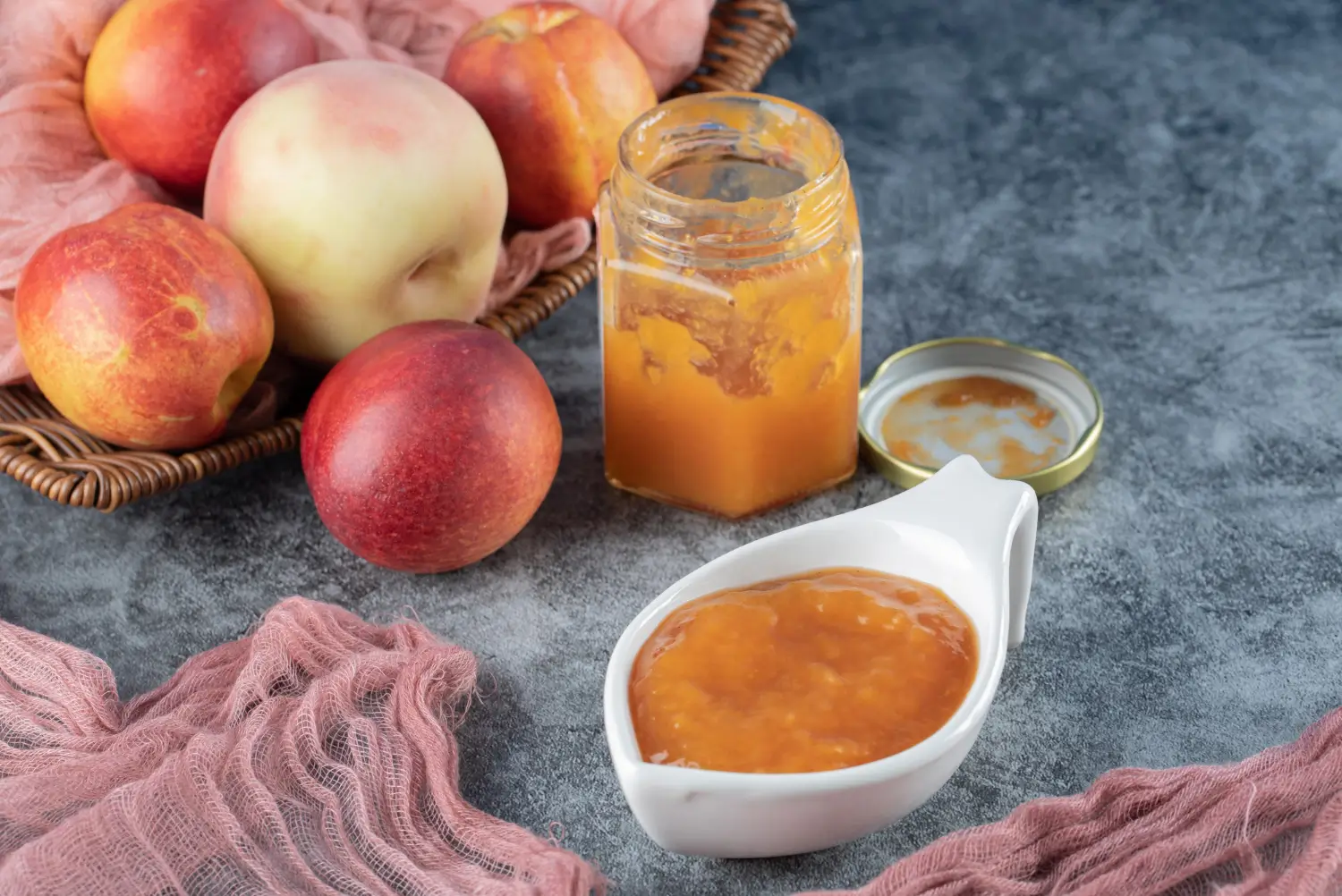 Homemade apple jam in a jar with fresh apples