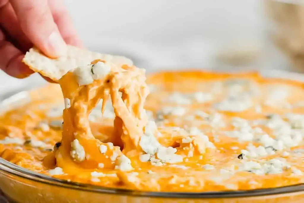 Buffalo chicken dip with shredded rotisserie chicken, cream cheese, and hot sauce, served with tortilla chips.