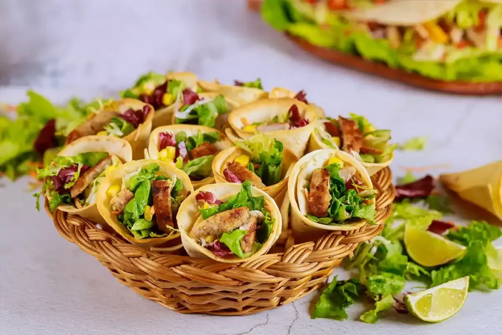 Chicken tacos with shredded rotisserie chicken, lime slaw, and avocado slices