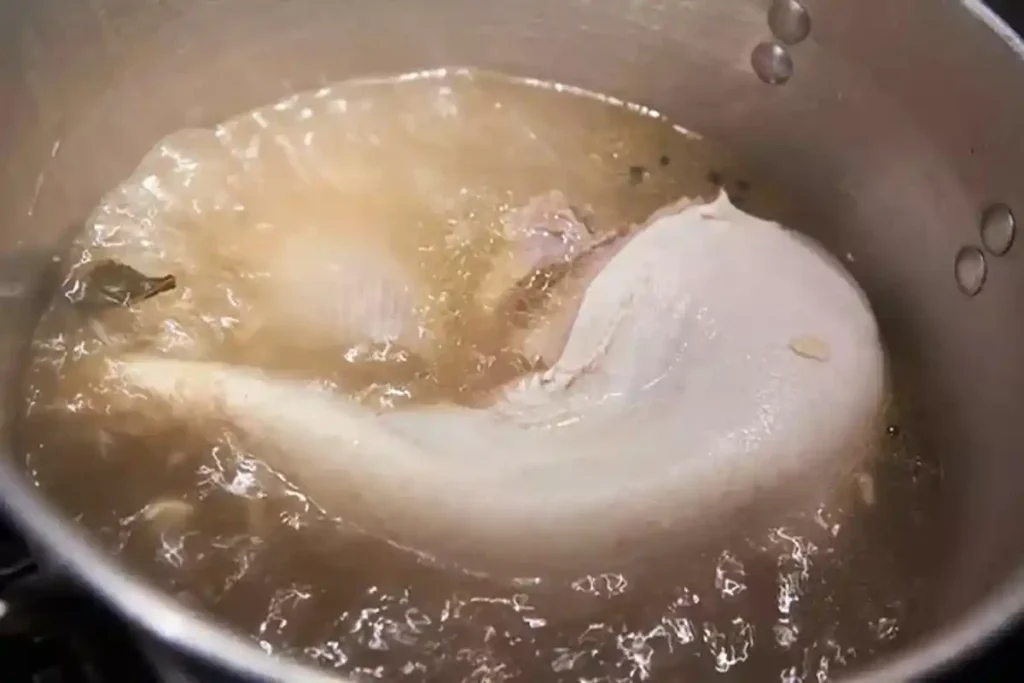 Beef tongue simmering in a pot with seasonings