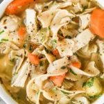 Close-up of Chicken Noodle Soup with Wide Noodles and Carrots